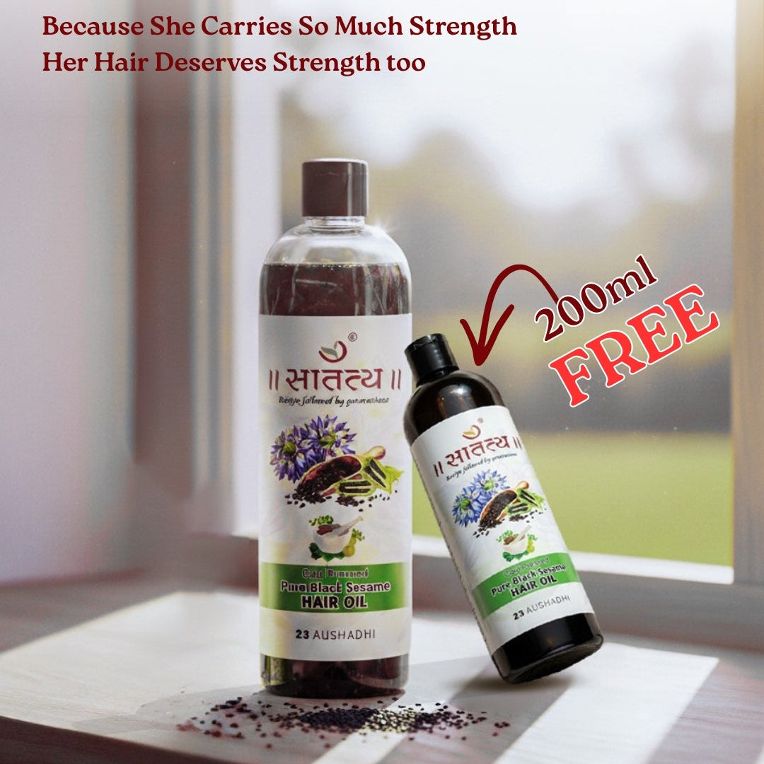 Two bottles of hair oil with a promotional message on a window sill.